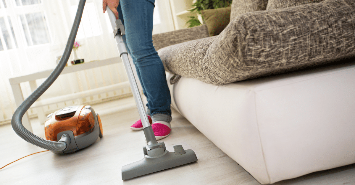 woman showing how to vacuum a carpet