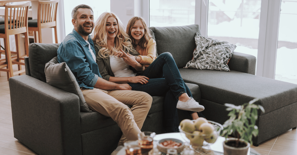 Joyful family gathers around in their home, sharing laughter and happiness
